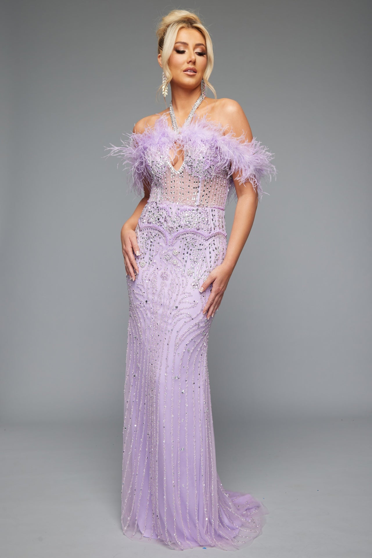 Style 7630: a chic fitted prom dress featuring beads, feathers, and a halter neckline. Shown in lilac and crafted to shine on the dance floor.