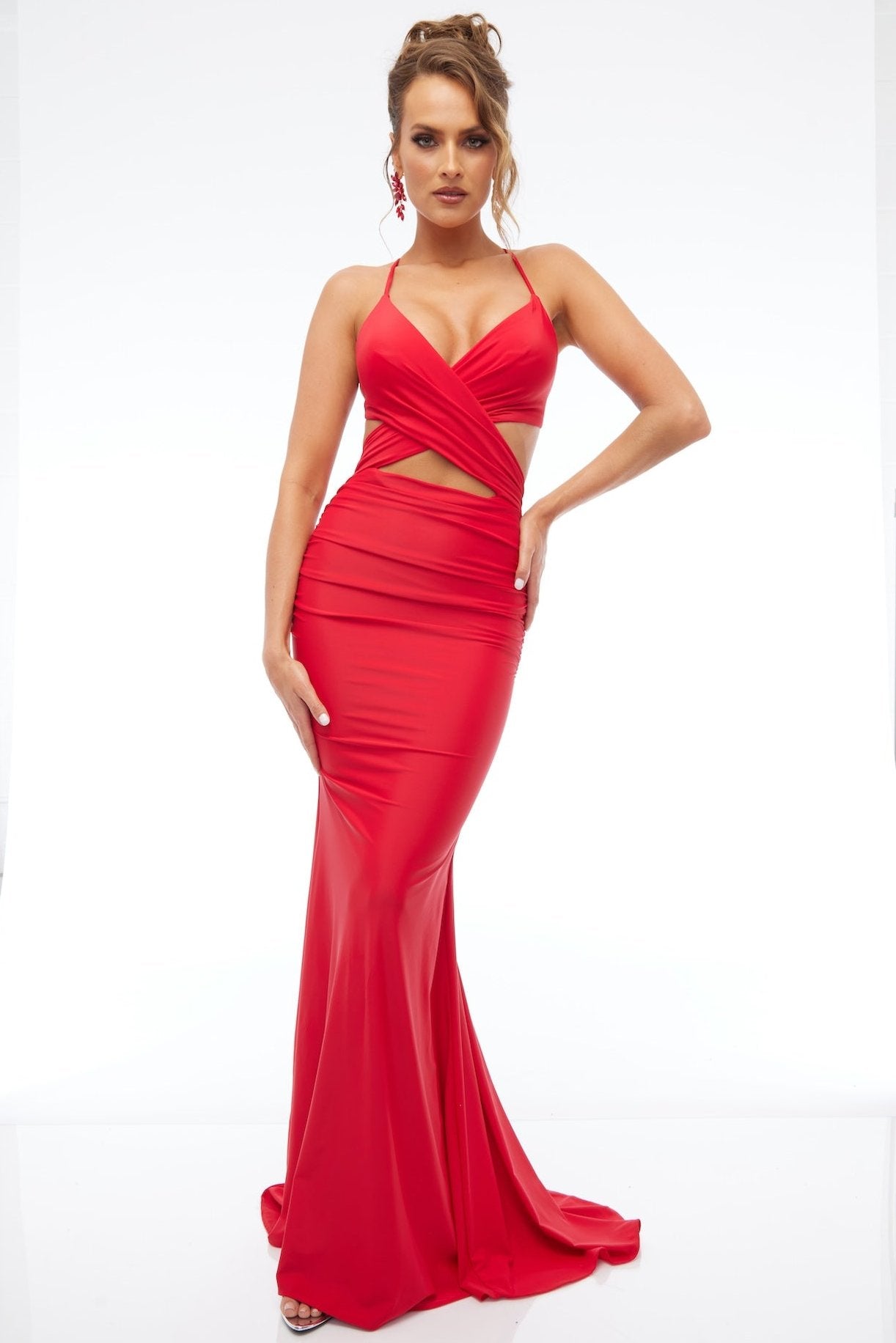 Front view of best selling Style 7683: a dazzling red prom dress featuring cutouts, halter, lace up back, and spaghetti straps.
