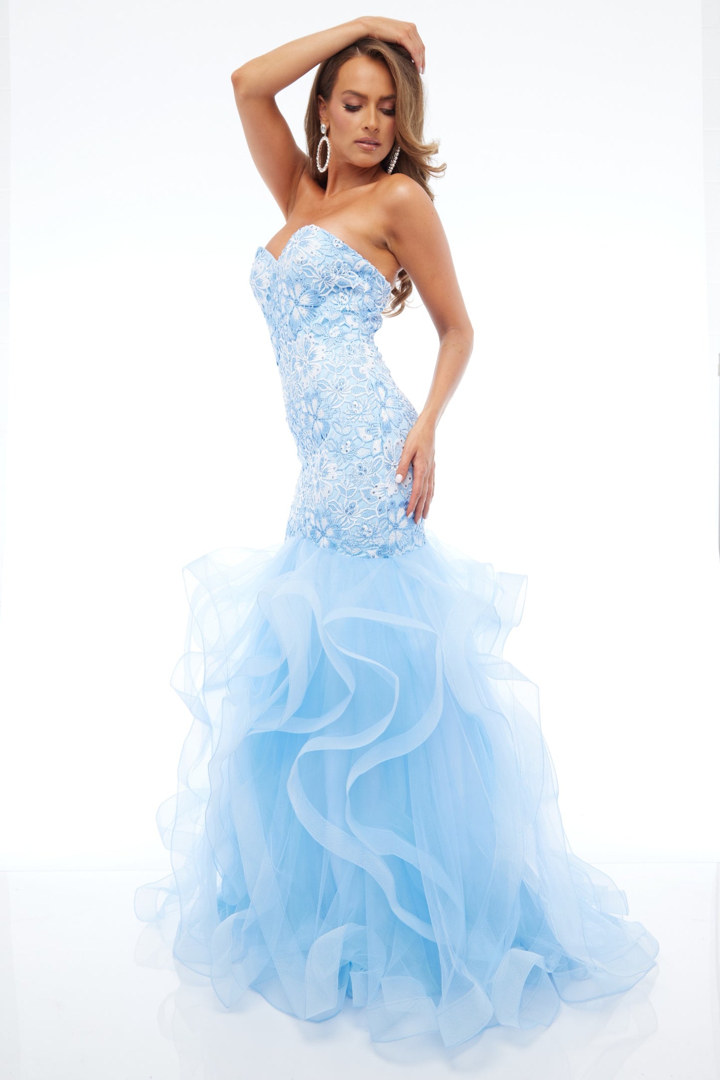 Side view of our glamorous best selling strapless prom dress in sky blue with tulle skirt, sweetheart neckline, and lace detail. Timeless, feminine, and perfect for prom 2025.
