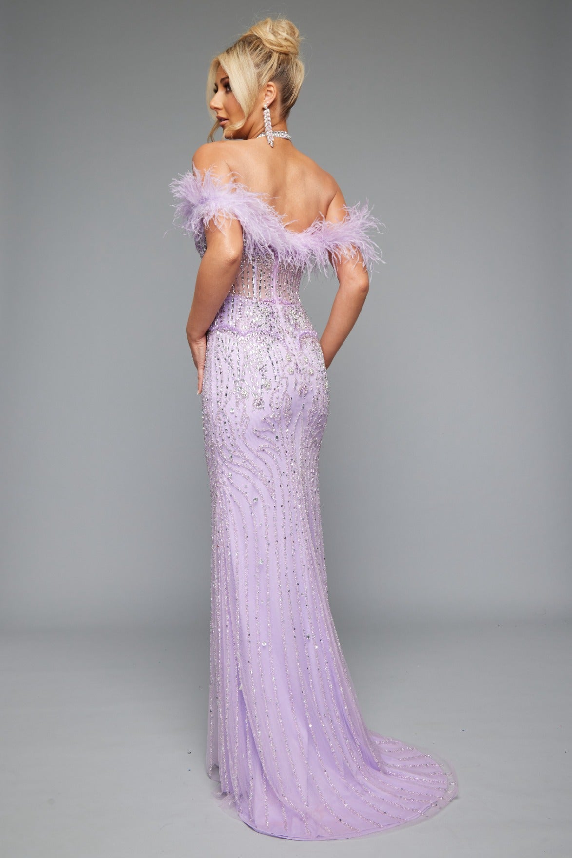 Back view of Style 7630: a chic fitted prom dress featuring beads, feathers, and a halter neckline. Shown in lilac and crafted to shine on the dance floor.