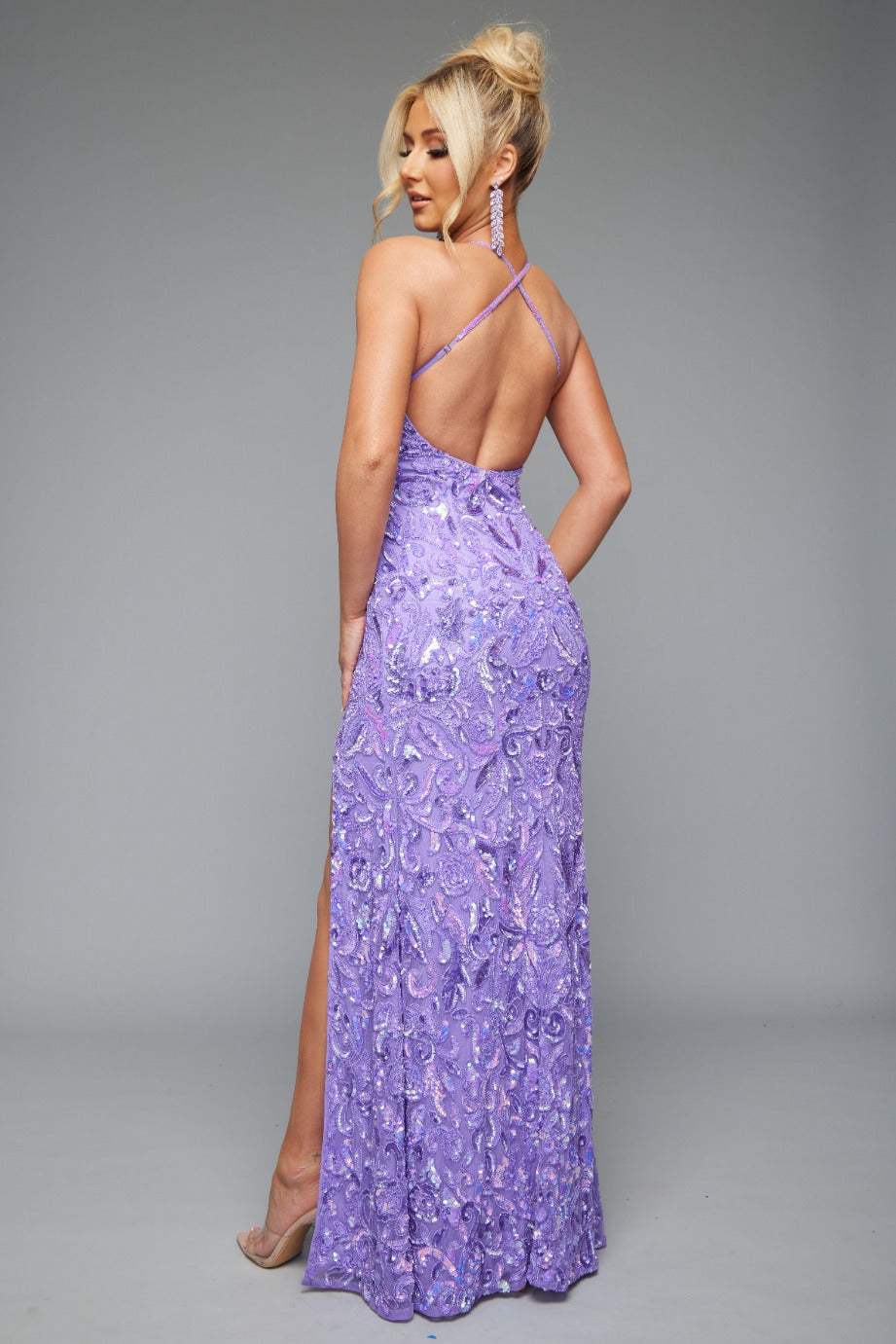 Back view of Jasz Couture Style 7632: a spaghetti strap fitted prom dress featuring a beaded patterned design, high slit, and open back. Shown in lilac and ideal for turning heads.