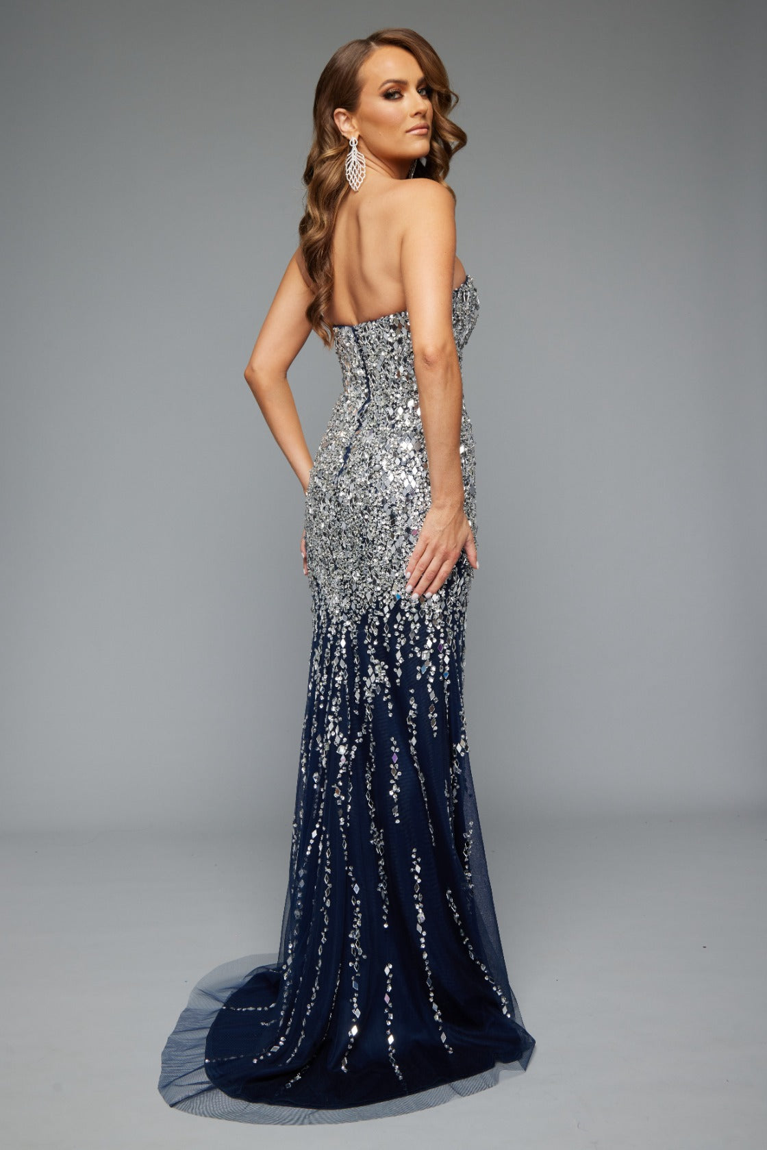 Back view of Jasz Couture Style 7638: a glamorous prom dress featuring a glimmering beaded design, and a strapless, sweetheart neckline. Shown in navy and a must-have for prom night.