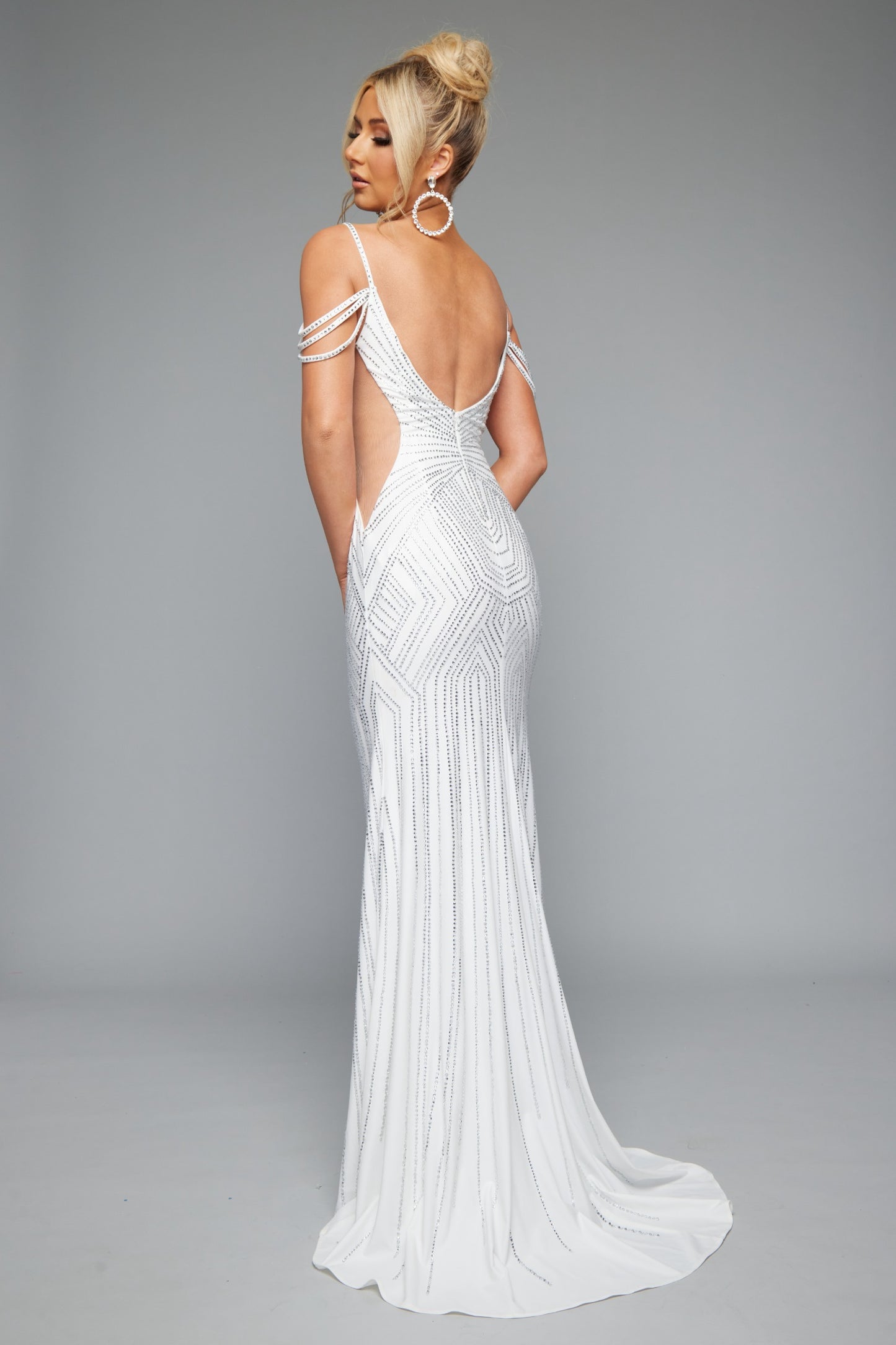 Back view of Jasz Couture Style 7642: an enchanting off the shoulders white prom dress featuring a beaded design, cutouts, open back, and spaghetti straps.