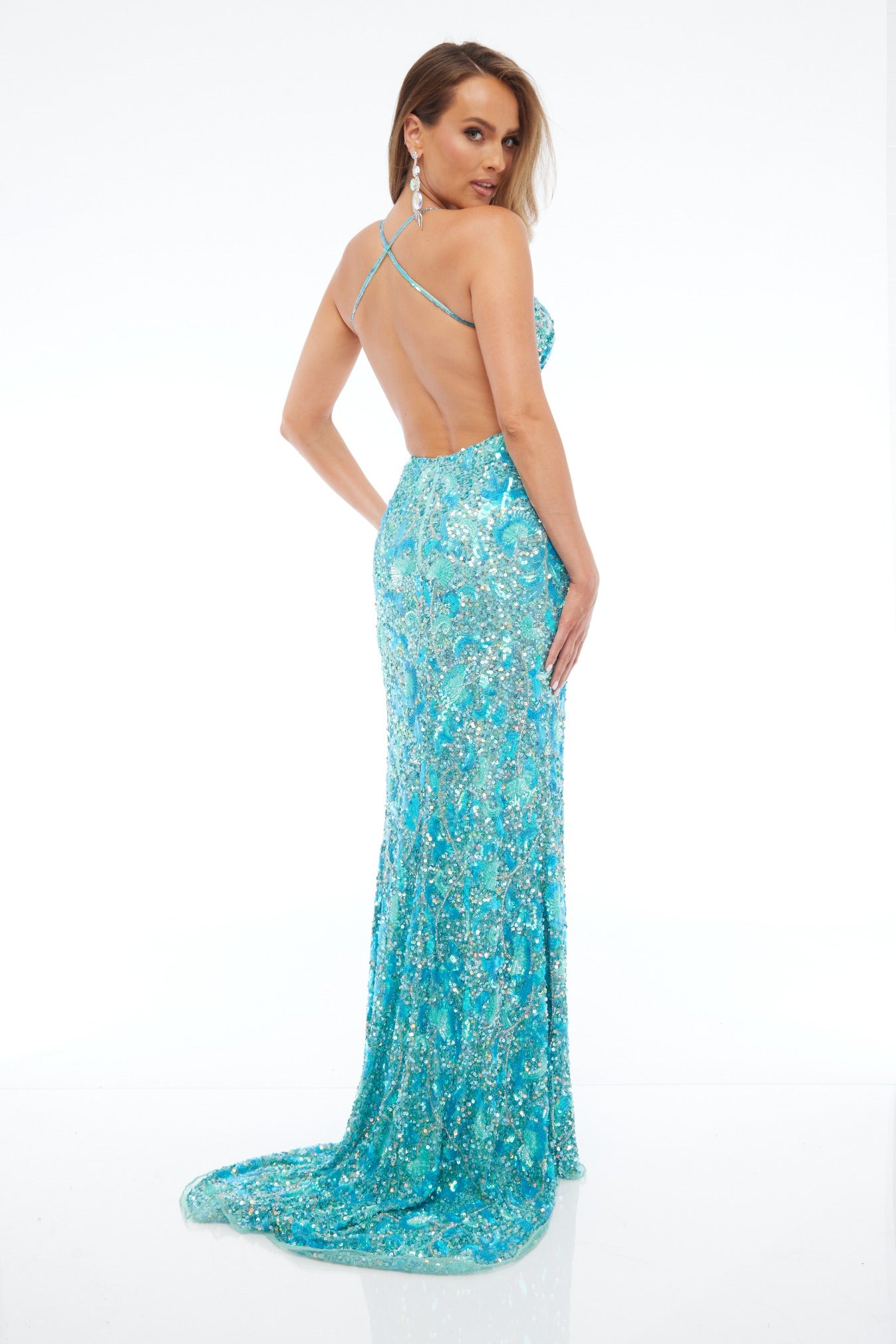 Back view of Jasz Couture Style 7643: an enchanting jade prom dress featuring a beaded design, open back, halter plunge neckline, and spaghetti straps.