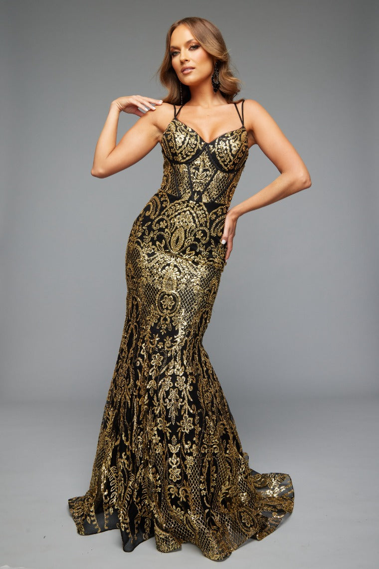 Front view of Style 7648: an eye-catching, best selling black and gold prom dress featuring an applique design, corset lace up detail, and spaghetti straps.