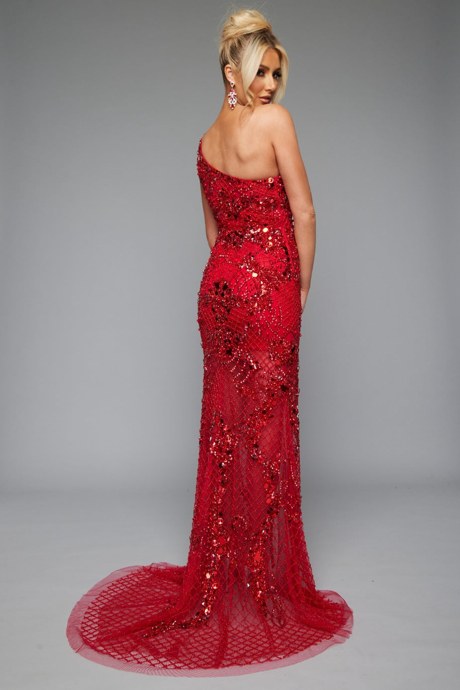 Back view of Jasz Couture Style 7653: an enchanting red prom dress featuring a beaded netting design, high slit, and one shoulder.