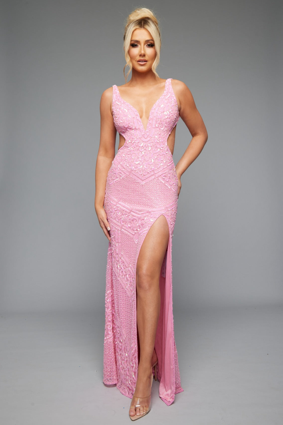 Front view of Jasz Couture Style 7654: an elegant pink prom dress featuring a detailed beaded design, cutouts, open back, and a plunge neckline.