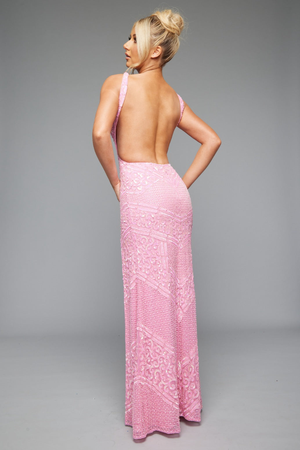 Back view of Jasz Couture Style 7654: an elegant pink prom dress featuring a detailed beaded design, cutouts, open back, and a plunge neckline.