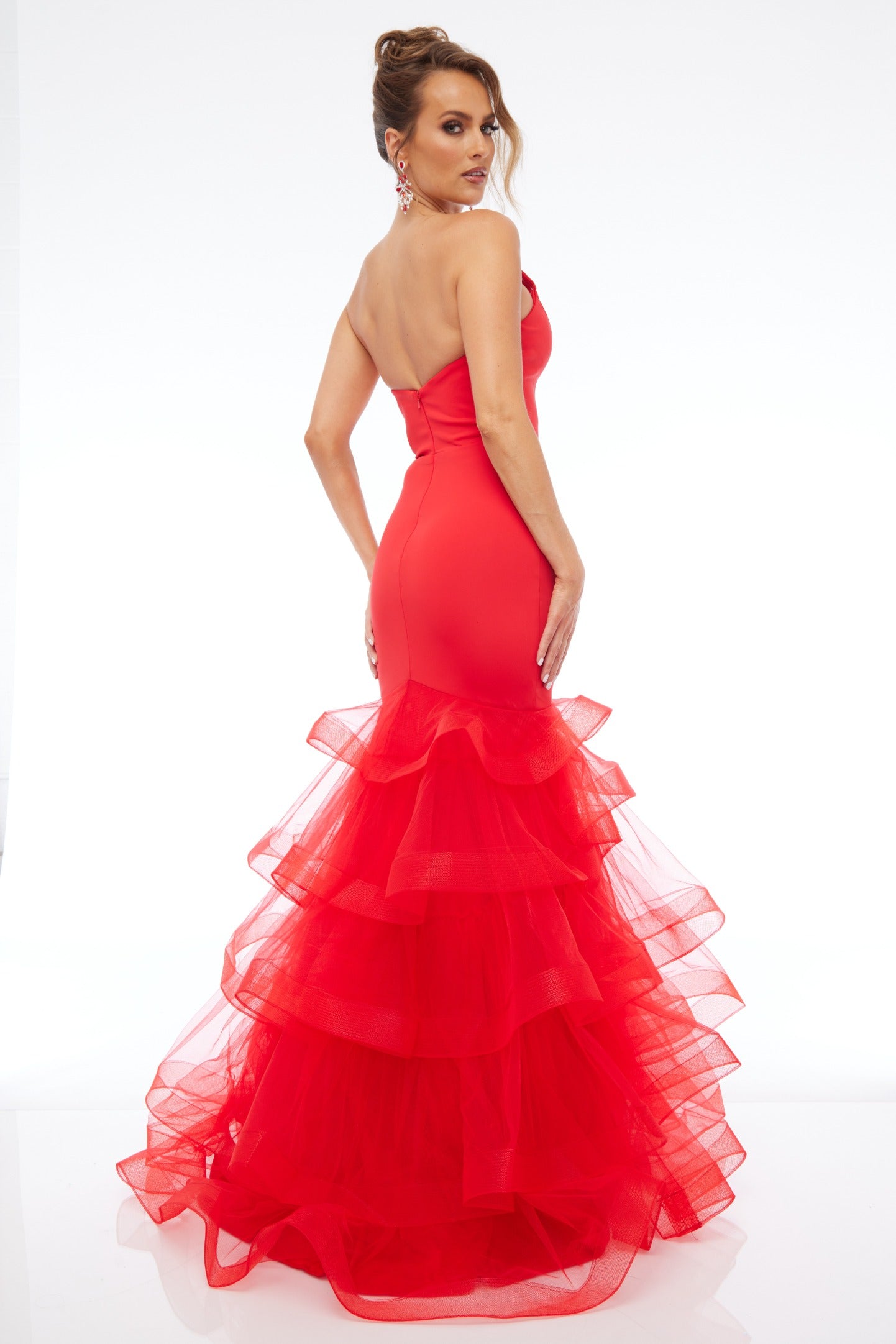 Back of Style 7670: a captivating fitted red prom dress with a strapless plunge neckline and tulle skirt.