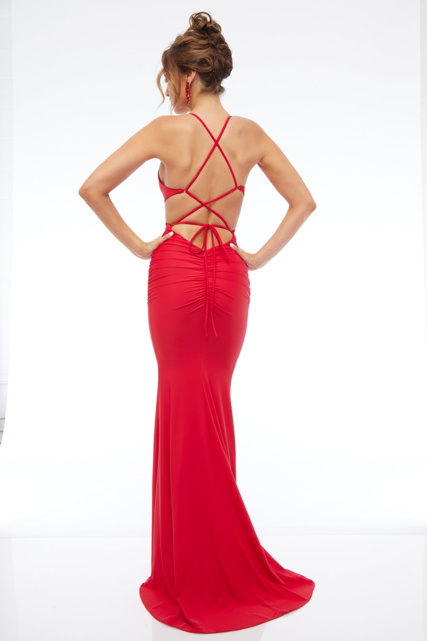 Back view of best selling Style 7683: a dazzling red prom dress featuring cutouts, halter, lace up back, and spaghetti straps.