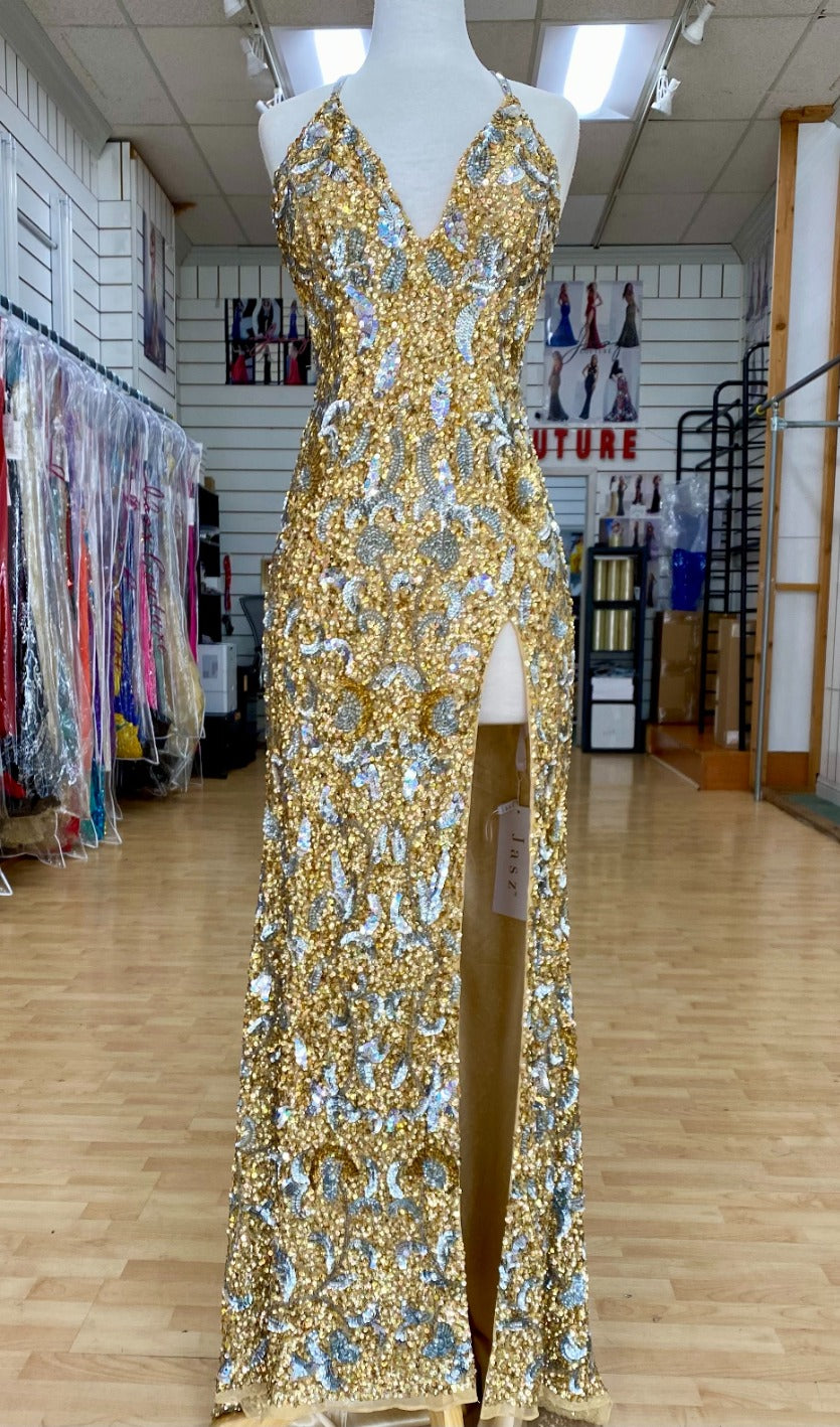 Front view of Jasz Couture Style 7643: an enchanting gold prom dress featuring a beaded design, open back, halter plunge neckline, and spaghetti straps.