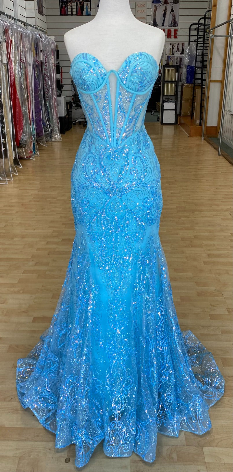 Front view of Style 7707: a bold strapless light blue prom dress featuring a sweetheart neckline and a corset lace up back.