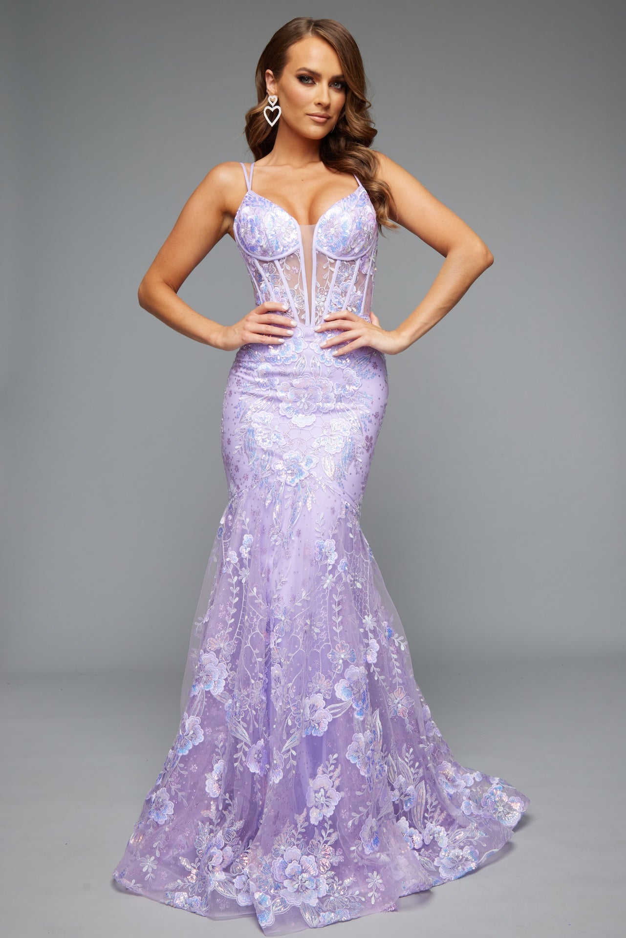 Front view of our best selling Style 7657: a feminine spaghetti strap prom dress with applique and corset lace up details shown in lilac.