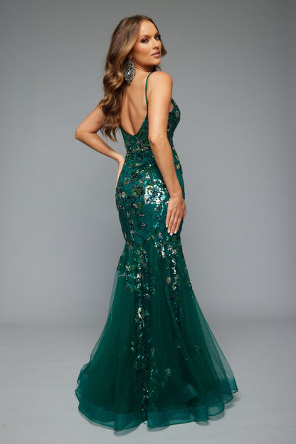 Back view of Jasz Couture Style 7619: a best-selling prom dress with a mermaid silhouette, tulle skirt, and applique details in green.