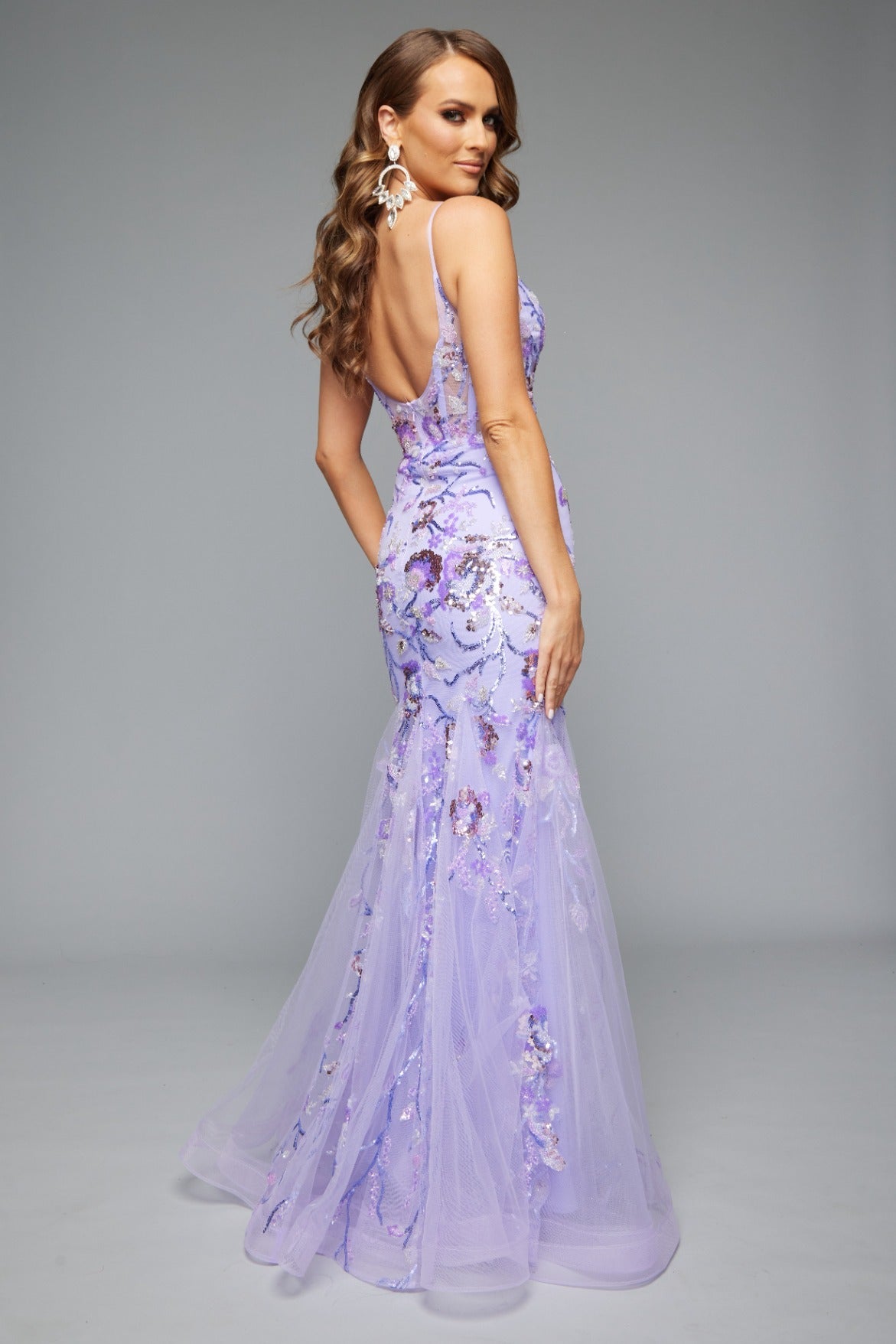 Back view of Jasz Couture Style 7619: a best-selling prom dress with a mermaid silhouette, tulle skirt, and applique details in lilac.