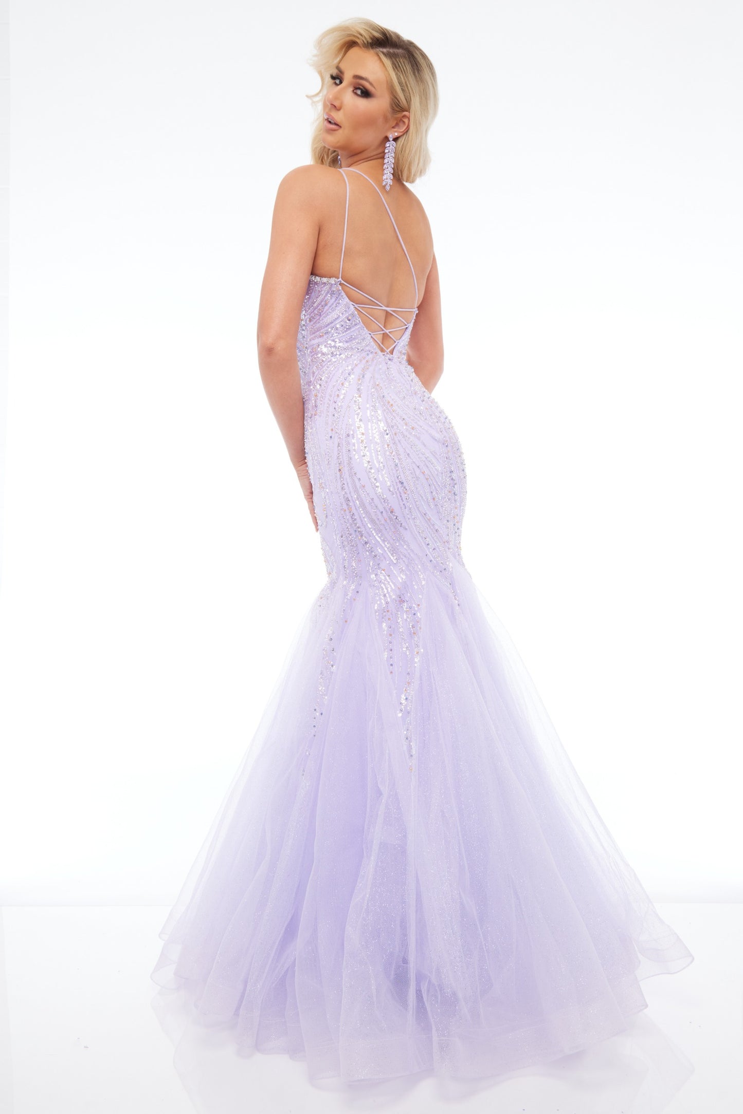 Back view of Style 7696: an enchanting fitted lilac prom dress featuring a beaded design, lace up back, one shoulder, and tulle skirt. 