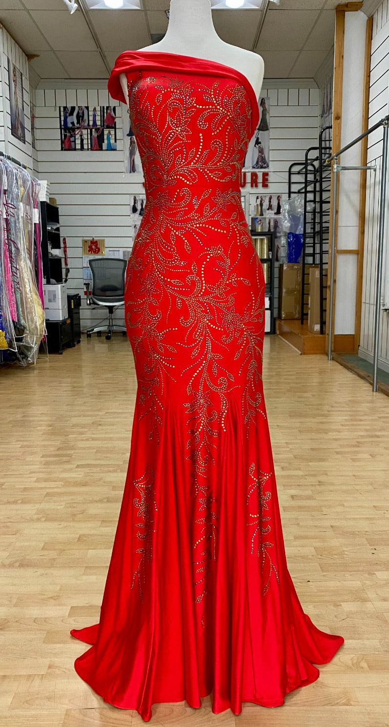 Front view of style 7621 prom dress with a beaded design, cut outs, and a unique one-shoulder off the shoulders neckline shown in RED, offering an elegant look.