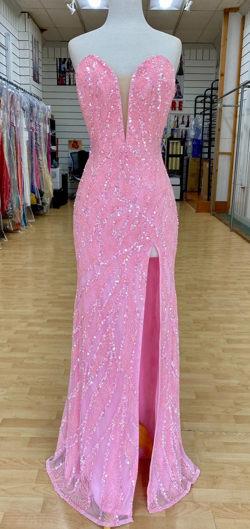 Front view of Jasz Couture Style 7666: a dazzling strapless pink prom dress featuring a beaded design, high slit, and a plunging sweetheart neckline.