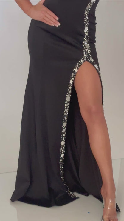 Video of our timeless strapless prom dress with high slit and mirror accents. Bold, sophisticated, and available in black or white.