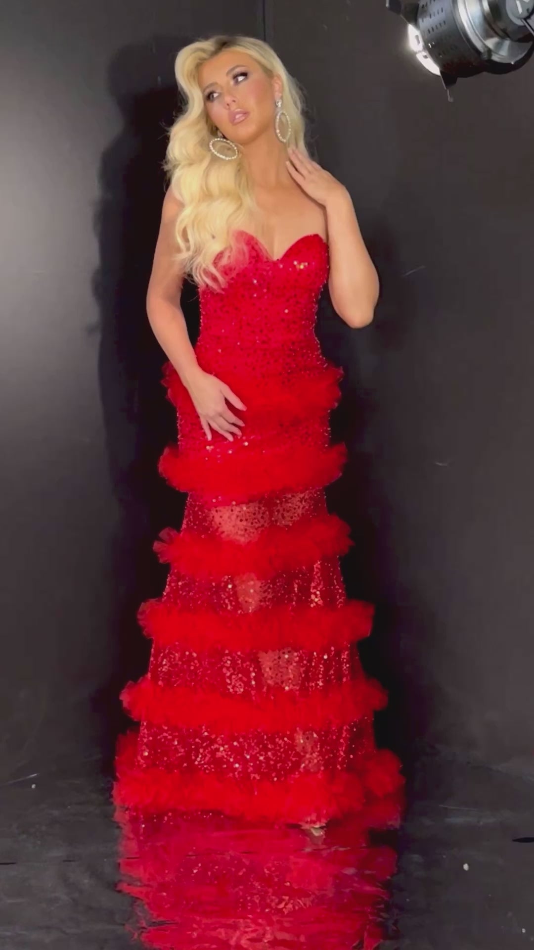 Stunning red sleeveless prom dress with a sweetheart neckline, sheer tulle skirt, and sequin accents. 